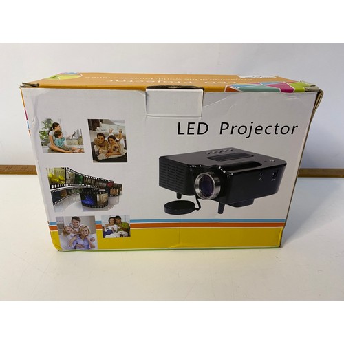 711 - Boxed LED projector in working order.