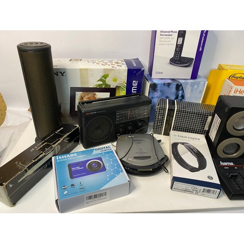 715 - Box of assorted small electricals including camera, fitbit, phones and radio.