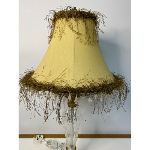 775 - Pair of glass column table lamps with fringed shades, in working order, measuring 57 cm tall.