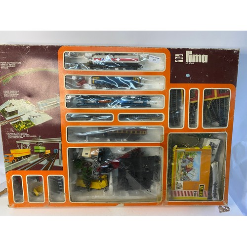 825 - Boxed Lima train set including trains, track, swing bridge and unloading containers