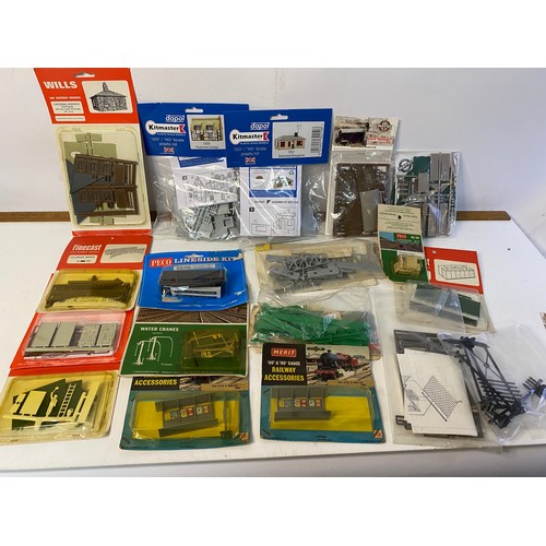 834 - Large selection of railway kit accessories including cottages, stalls, stages, bridges