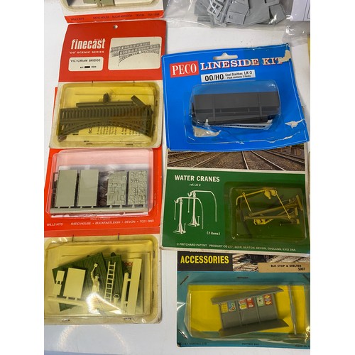 834 - Large selection of railway kit accessories including cottages, stalls, stages, bridges