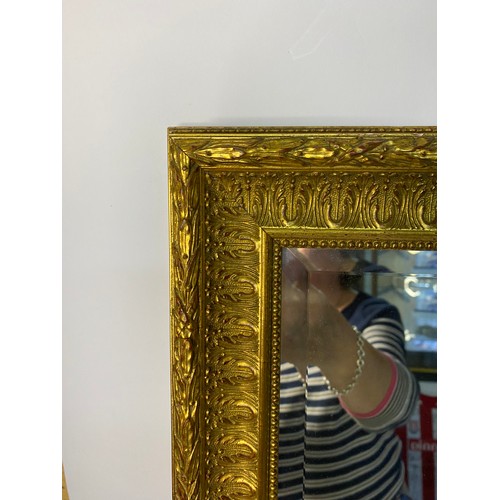 875 - 2 x ornate gold framed bevelled mirrors, one measuring 96 x 66 cms and one measuring 72 x 58 cms