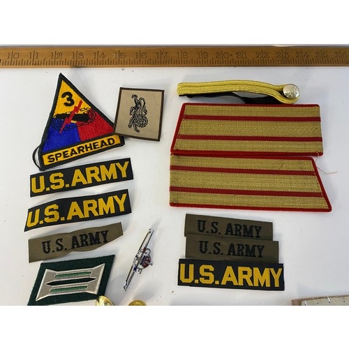 587 - Selection of military badges, patches, buttons and tags.