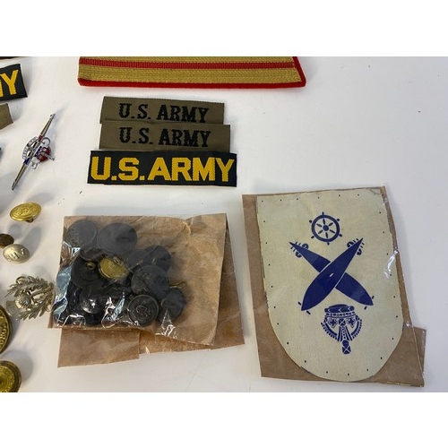 587 - Selection of military badges, patches, buttons and tags.