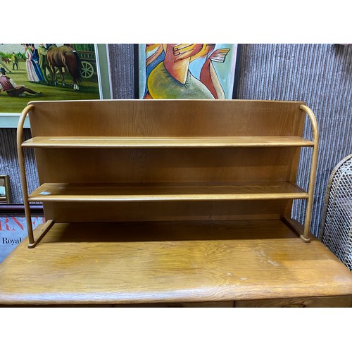 955 - Ercol style light oak sideboard with concertina opening door, 3 drawers and display shelving to top.