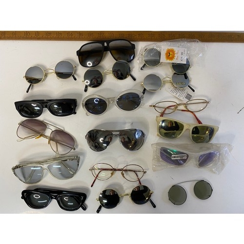 813 - Selection of sunglasses in many shapes and sizes.