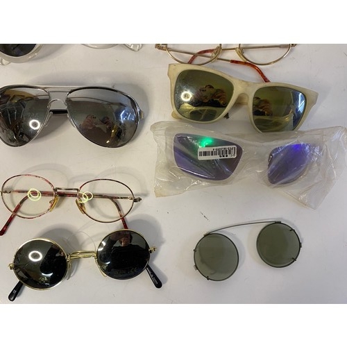 813 - Selection of sunglasses in many shapes and sizes.