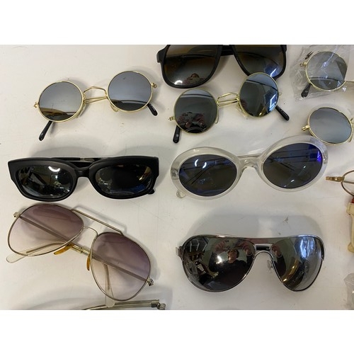 813 - Selection of sunglasses in many shapes and sizes.