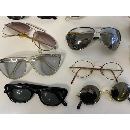 813 - Selection of sunglasses in many shapes and sizes.