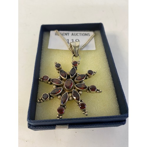 119 - 925 silver garnet star pendant on silver chain.