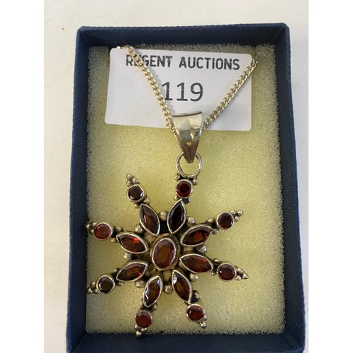 119 - 925 silver garnet star pendant on silver chain.