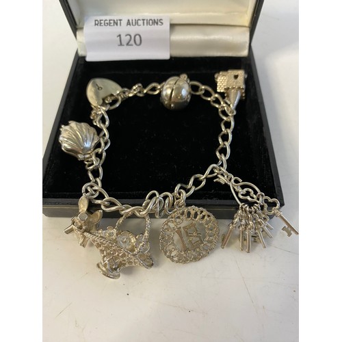 120 - Silver charm bracelet with 7 charms.