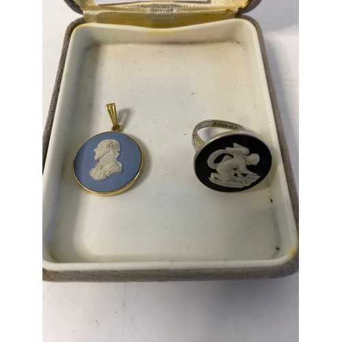 123 - 3 pieces of vintage Wedgwood jewellery. A large blue Jasperware pendant set in silver on silver chai... 