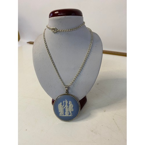 123 - 3 pieces of vintage Wedgwood jewellery. A large blue Jasperware pendant set in silver on silver chai... 