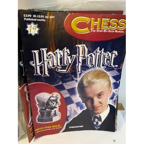 145 - Selection of Harry Potter items including chess pieces, games and audiobooks.