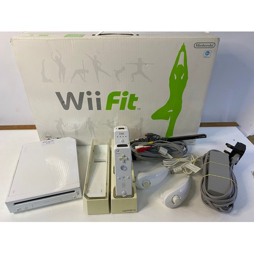 175 - Nintendo Wii console with fit board, controllers and nunchucks. Tested and working