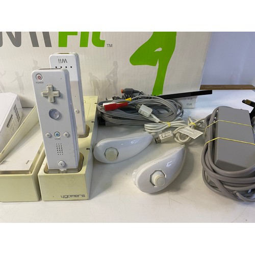 175 - Nintendo Wii console with fit board, controllers and nunchucks. Tested and working