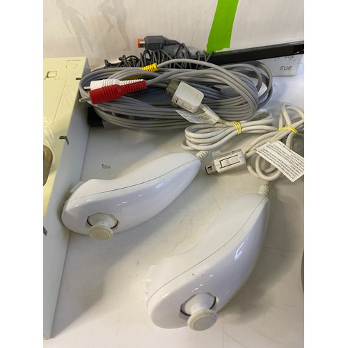 175 - Nintendo Wii console with fit board, controllers and nunchucks. Tested and working