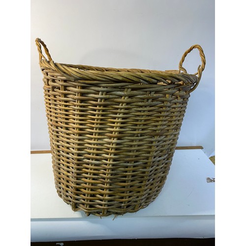 394 - Large wicker log basket complete with logs measuring approx 50 cms tall