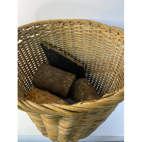 394 - Large wicker log basket complete with logs measuring approx 50 cms tall