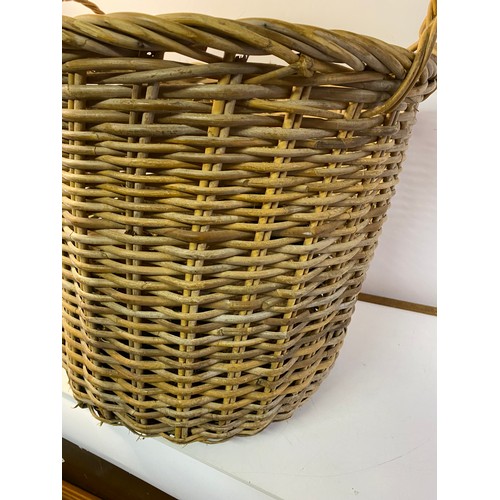 394 - Large wicker log basket complete with logs measuring approx 50 cms tall