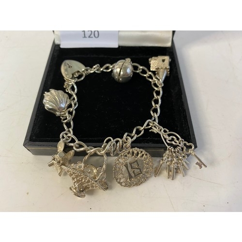 120 - Silver charm bracelet with 7 charms.