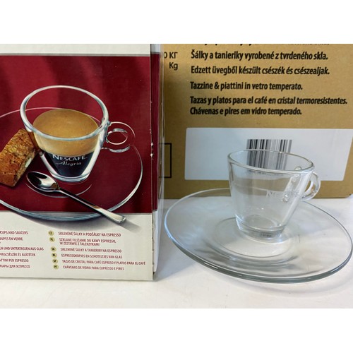 103 - 2 boxes of Nescafe Alegria glass coffee cups and saucers. Each box contains 8 sets of 2.