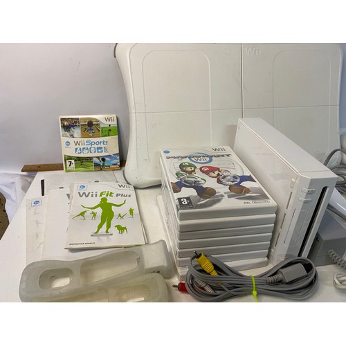 132 - Nintendo Wii console with games and accessories including fit board and Mario Kart.