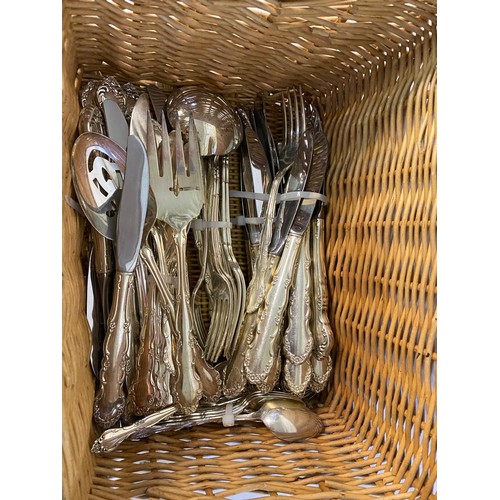 215 - Basket containing approximately 125 pieces of silver plated items of cutlery.