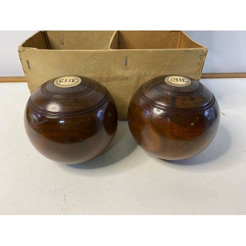 222 - Pair of antique Thomas Taylor lignum vitae lawn bowls in original cardboard box