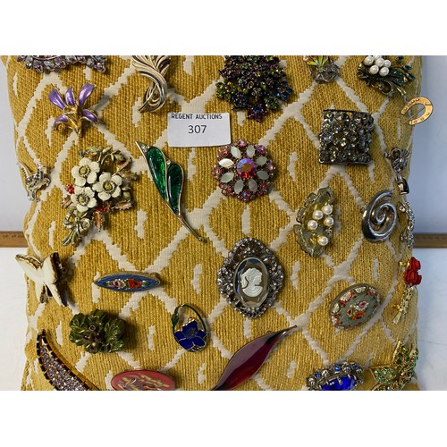 307 - Selection of vintage brooches on cushion.