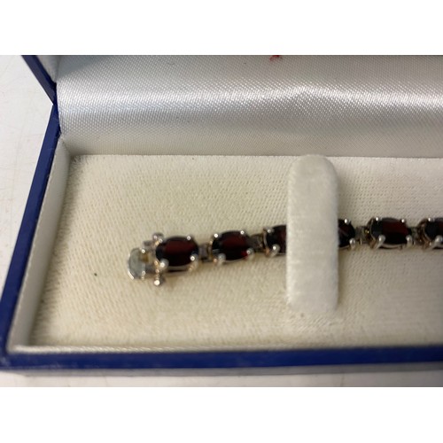 312 - 925 silver and garnet tennis bracelet.