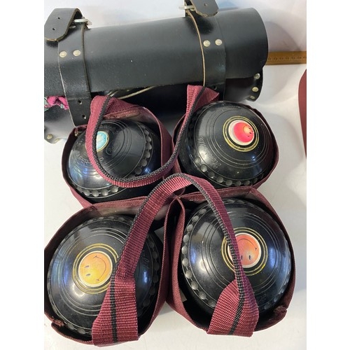 151 - An assortment of lawn bowls in carry case.