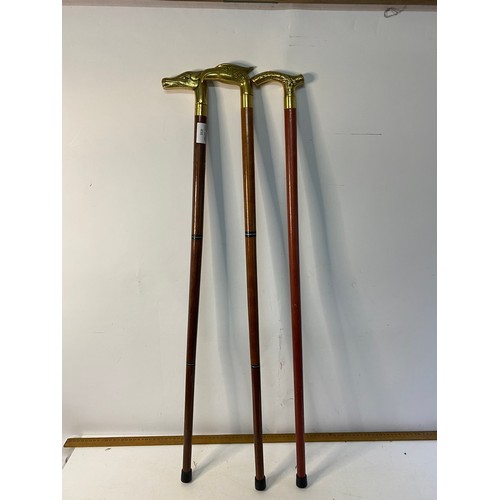 498 - 3 brass headed walking sticks.