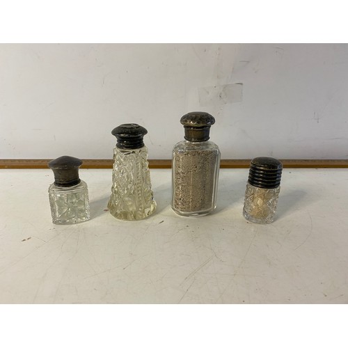 39 - 4 Silver topped scent bottles.