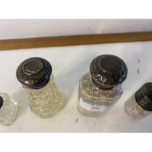 39 - 4 Silver topped scent bottles.