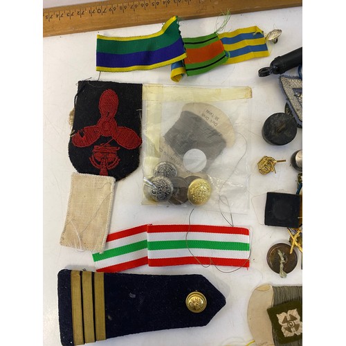 57 - Selection of Militaria including badges, patches, buttons, pins and ribbons.