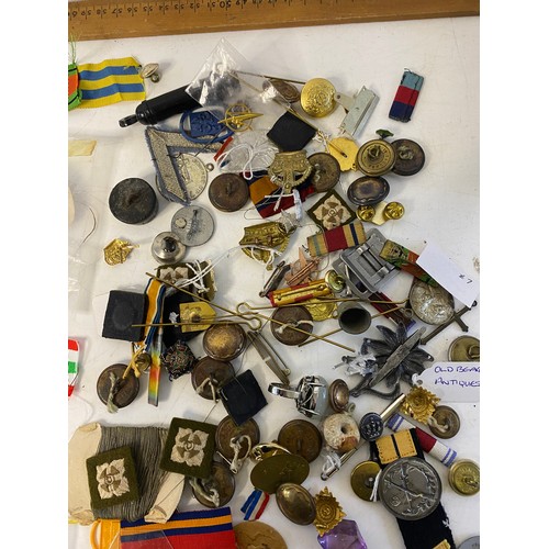 57 - Selection of Militaria including badges, patches, buttons, pins and ribbons.