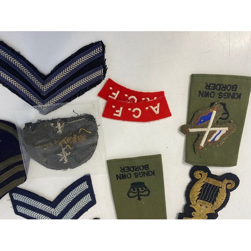 64 - Collection of vintage military patch badges.