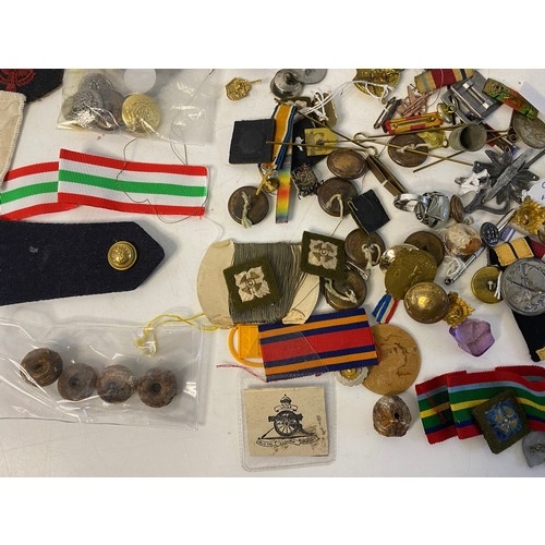 57 - Selection of Militaria including badges, patches, buttons, pins and ribbons.