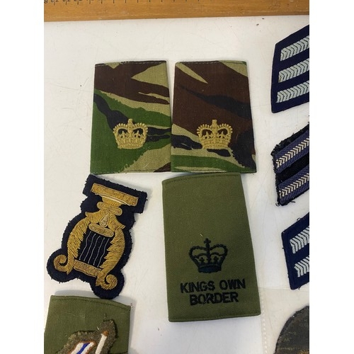 64 - Collection of vintage military patch badges.