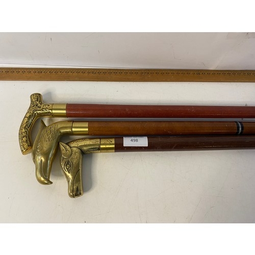 498 - 3 brass headed walking sticks.