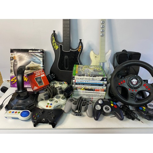 627 - Box of video gaming accessories including controllers, games and guitars.