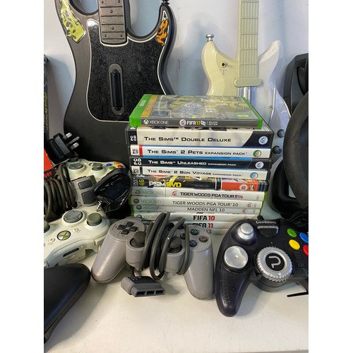 627 - Box of video gaming accessories including controllers, games and guitars.