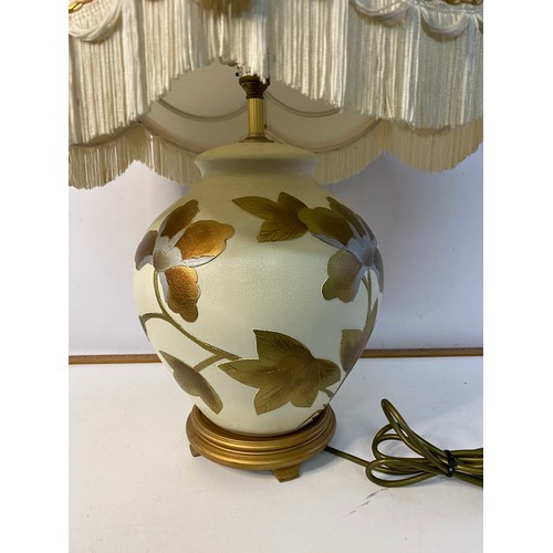 639 - Large cream and gold table lamp with shade 70cms tall in working order.