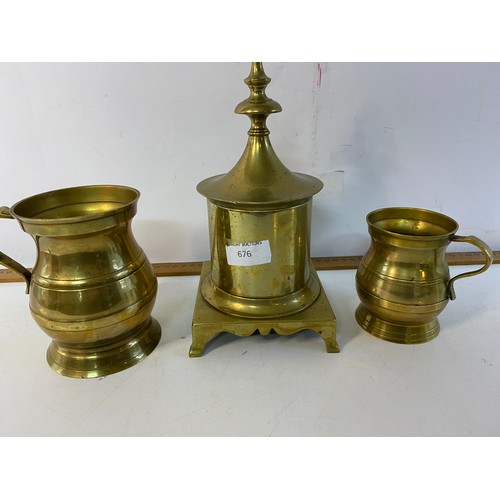 676 - Victorian brass tobacco jar with lead cover plus a set of graduating brass tankards.