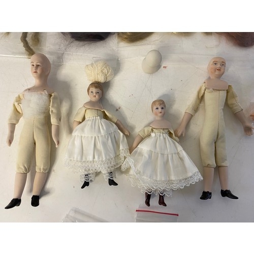 673 - Collection of vintage miniature porcelain soft bodied dolls with hairpieces.