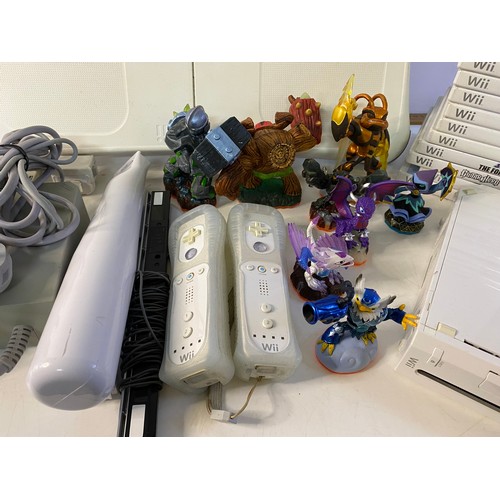 705 - Nintendo Wii console with games and accessories including fit board, Skylanders bundle etc. Front pa... 