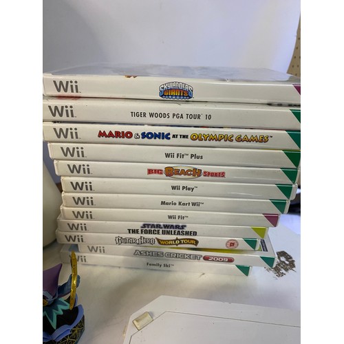 705 - Nintendo Wii console with games and accessories including fit board, Skylanders bundle etc. Front pa... 